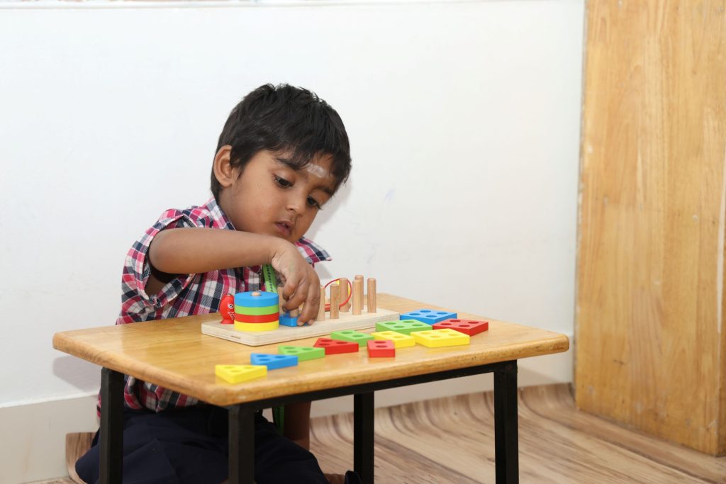 A child stacking a Montessori sorting toy